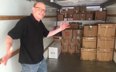 Aprio managing director Robert Melnick arranges boxes to maximize space in a U-Haul truck bound to Miami with relief supplies.