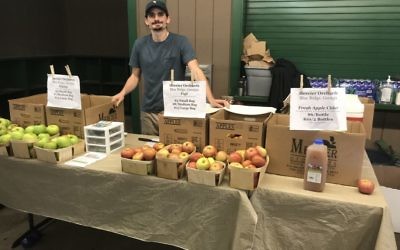 Steven Goyne of Mercier Orchards poses with some favorite apple varieties at the first annual Sukkot Farm-to-Table Festival Oct. 8.