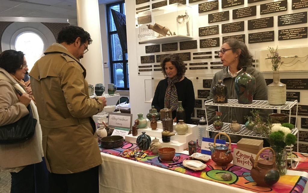 Abby Friedman (right) showcases her handmade ceramics at the 2017 OVS Chanukah Bazaar.