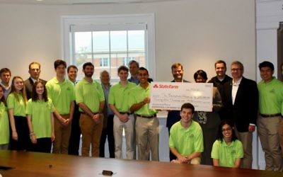 Surrounded by his team, local State Farm agents and Dean Benjamin Ayers from the Terry College of Business, Backpack Project founder Zack Leitz is presented a $25,000 check from the State Farm Neighborhood Assist program in Correll Hall at the University of Georgia on Dec. 6.