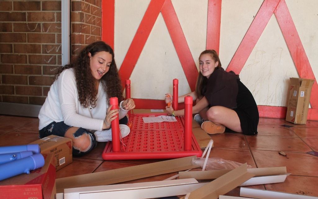 Weber School students work to prepare the preschool space for Los Niños Primero.