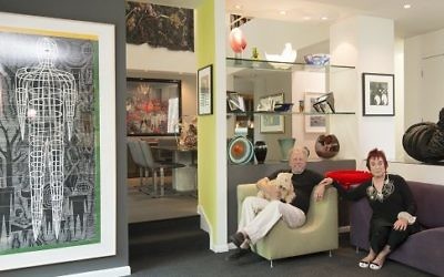 Harvey and Lakeland terrier Remy Mae relax with Eve Mannes in their art-filled home, which includes a life-size print by John Buck (left) and a black sculpture titled “Cauldron” by Heide Fasnacht. (Photo by Duane Stork)