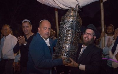 Ron Manoah and Rabbi Mendy Gurary carry the Sephardic Torah.