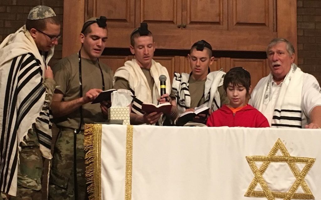 Retired Navy Capt. Neil Block (right) and 11-year-old Avi Heart join U.S. Army troops on the bimah of the Regimental Chapel at Fort Benning on Dec. 3. (Photo by Ahava Heart)