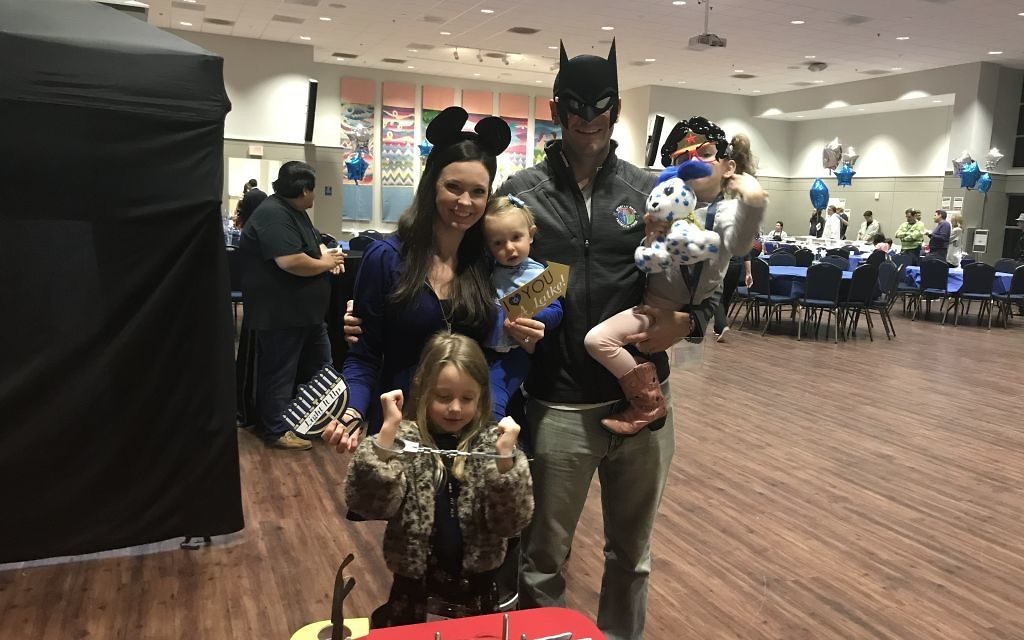 Parents Heather and Jeremiah Jarmin enjoy the camp expo while getting playful in costumes with children Ariella, 6, Zipporah, 4, and Davinah, 15 months.