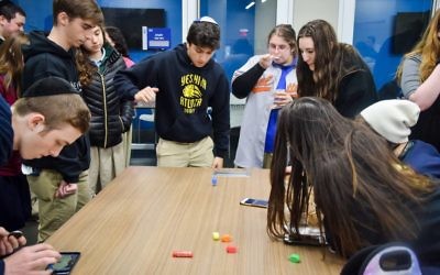 Atlanta Jewish Academy Upper School students participate in a dreidel competition.