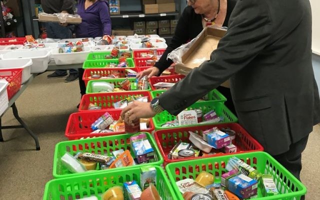 Rabbi Mark Zimmerman and others pack groceries for meal donations at Congregation Beth Shalom on Wednesday, Feb. 7.