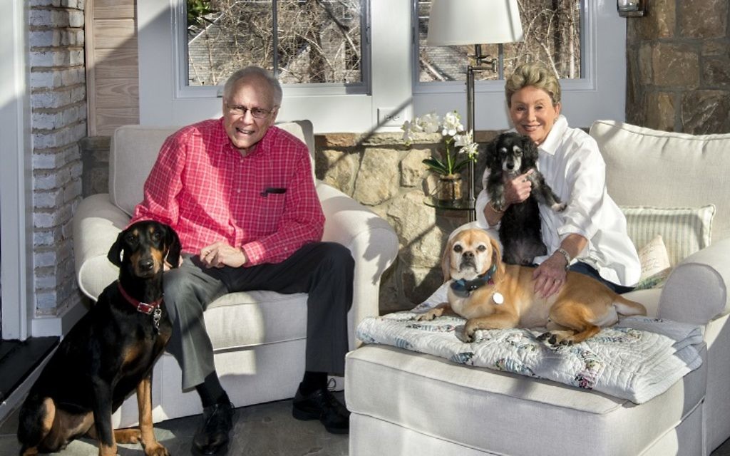 Ron and Judy Goldstein relax in the art studio/sunroom with treasured pups Kirby, a puggle, Carly, a rescue of unknown lineage, and Ella (Judy’s name for her) or Della (Ron’s name), a Doberman rescue. (Photo by Duane Stork)
