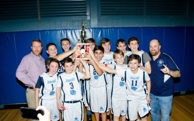 The AJA Jaguars celebrate their MAAC Division 2 middle school basketball championship Jan. 25. (Photo by Eli Gray)