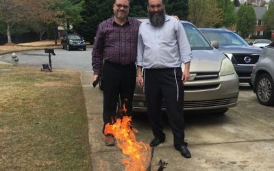 Rabbis Michael Bernstein and Hirshy Minkowicz burn the chametz March 30.