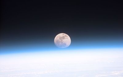 The full moon is seen through the haze of Earth's atmosphere from the space shuttle Discovery on Dec. 21, 1999.