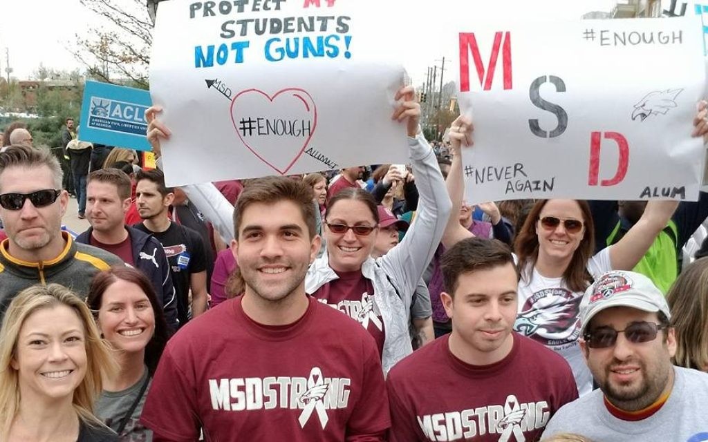Marjory Stoneman Douglas alumni represent the school with banners and homemade signs.