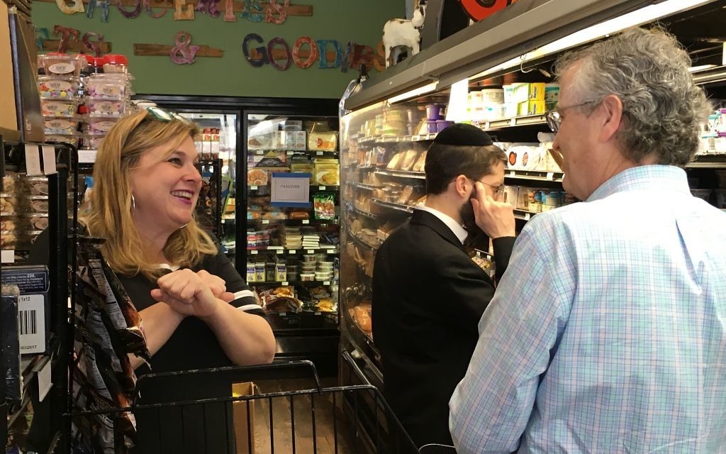 The Spicy Peach co-owner Jodi Wittenberg helps a customer on a crowded Sunday before Passover. (Photo by Leah R. Harrison)