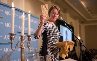 The Temple’s Rabbi Loren Filson Lapidus explains matzah and its meaning to the more than 400 people attending the Atlanta Unity Seder.