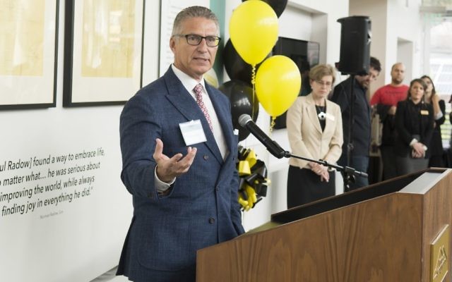Norman Radow helps open the Kennesaw State exhibit honoring his father March 30. (Photo by David Caselli, Kennesaw State University)