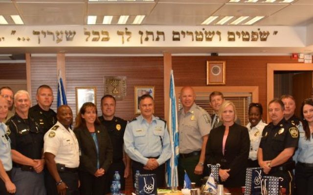 A 2014 delegation of American law enforcement officials organized by GILEE visits the Israeli police commissioner’s office. The Hebrew inscription on the wall is from Deuteronomy 16:18: “You shall appoint judges and officers in all your gates.”