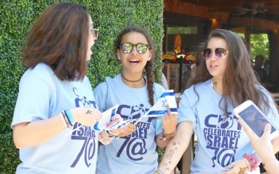 Henna from the AJT Chill Zone supplements the look of the frequently seen Congregation Dor Tamid T-shirts. Some 50 members of the Johns Creek congregation attended as a group.