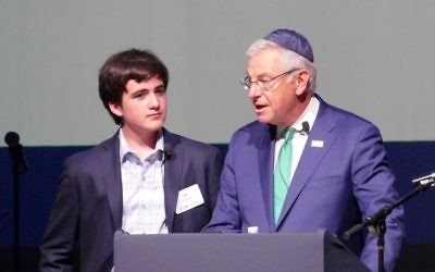 Ziv Zusman (left), the founder of JNF's Sababa Society, listens to Alan Lubel's vow to keep JNF vibrant for generations to come April 19 at the Buckhead Theatre.