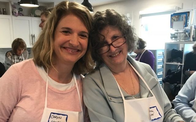 Caryn Hanrahan (left) and Jeanney Kutner prepare treats for Holocaust survivors.
