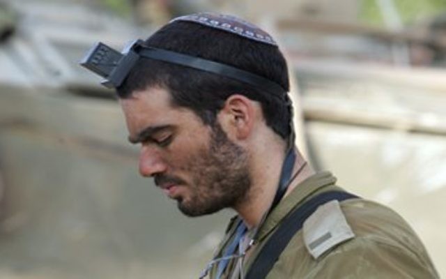 Rabbi Arnold Goodman sent this photo of an IDF soldier davening as an example of Israel's mix of tradition and modernity.