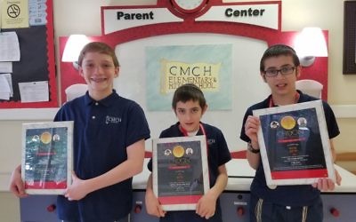 (From left) Aaron Linder, Levi Charytan and Shraga Charytan from Chaya Mushka Children's House hold their Chidon plaques. (CMCH photo)