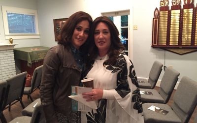 Dena Schusterman (left) welcomes Dina Hurwitz to Intown Jewish Academy on April 24. (Photo by Marcia Caller Jaffe)