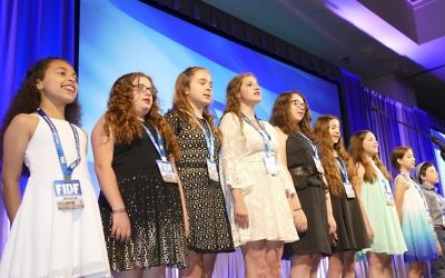 Epstein School students, including Garry Sobel's saughter, sing "Hatikvah" after singing "The Star-Spangled Banner" to open the FIDF gala.
