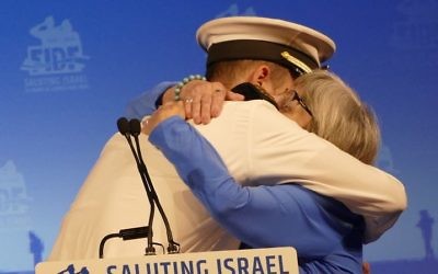 Lt. Y gets a hug from his grandmother Judith, a survivor of the Holocaust from Poland, during the FIDF gala at the InterContinental Buckhead on May 14.