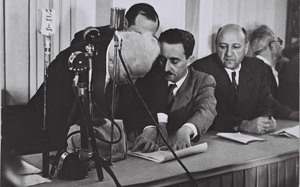 (From left) David Ben-Gurion, Moshe Shertok and Eliezer Kaplan participate in the signing of Israel’s Declaration of Independence. (National Photo Collection of Israel)