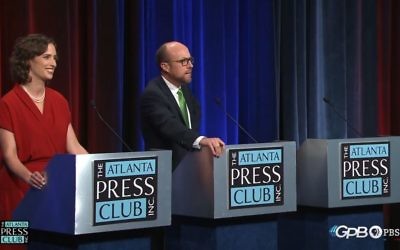 John Noel turns away from Lindy Miller to ask Johnny C. White's empty chair a question during the Atlanta Press Club debate. (YouTube screen grab)