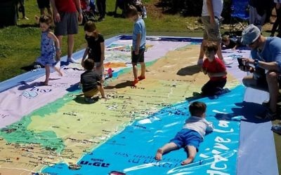 The play-mat map of Israel at the Israel@70 celebration is symbolic of Israel’s role to support the Jewish people. (Photo by Kaylene Ladinsky)