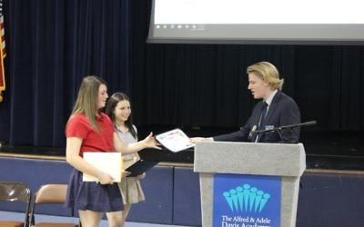 Jessie Schulhoff (left) and Ava Stark receive the StudentCam honorable mention from C-SPAN representative Joel Bacon. (Photo courtesy of the Davis Academy)