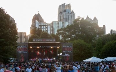 Midtown skyscrapers provide a scenic background for the Atlanta Jazz Festival at Piedmont Park.