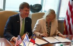 Economic Development Commissioner Pat Wilson and Ambassador Judith Varnai Shorer sign the memo of understanding June 7.