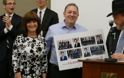 Leah and Andy Lewis receive a collage of tehir four sons graduating from Yeshiva Ohr Yisrael.