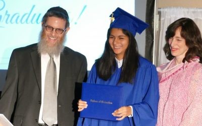 Head of School Rabbi Michoel Druin and school founder Dassie New present the first diploma in the history of the Chaya Mushka Children’s House Elementary & Middle School to Miriam Farkas.