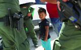 Photo by John Moore/Getty Images -  U.S. Border Patrol agents take into custody a father and son from Honduras near the U.S.-Mexico border on June 12, 2018 near Mission, Texas.