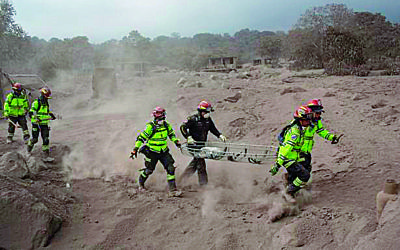 Rescuers rush to provide aid to victims after a volcano erupts in Guatemala.