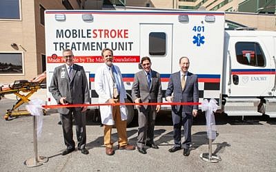 Cutting the ribbon for the new Grady mobile stroke unit was (from left): John Haupert, of Grady Health System; Michael Frankel, Marcus Stroke Network and Vascular Neurology at Emory School of Medicine; Bruce Inverso, American Heart Association; and Jonathan S. Lewin, Emory University health affairs and Woodruff Health Sciences Center.