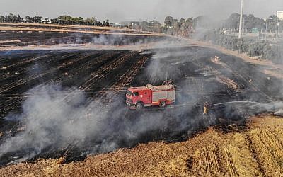 An Israeli fire truck tries to douse a devastating fire in Eshkol, Israel, caused by flaming kites.
