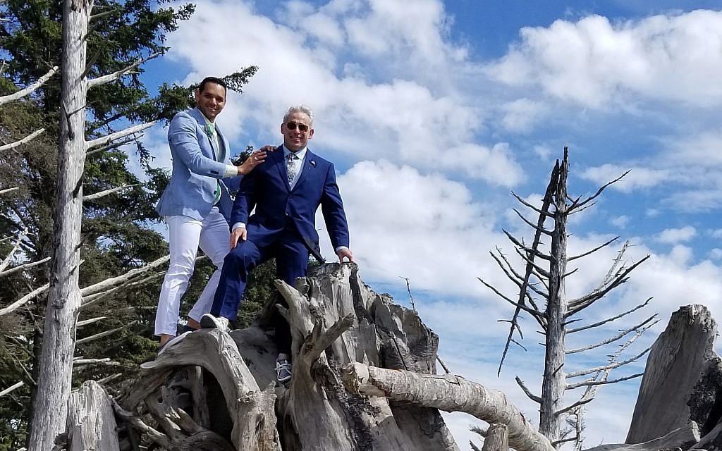 Rabbi Joshua Lesser and Alessandro 
"Alex" Ramaldes show the great heights they've scaled to be married.
