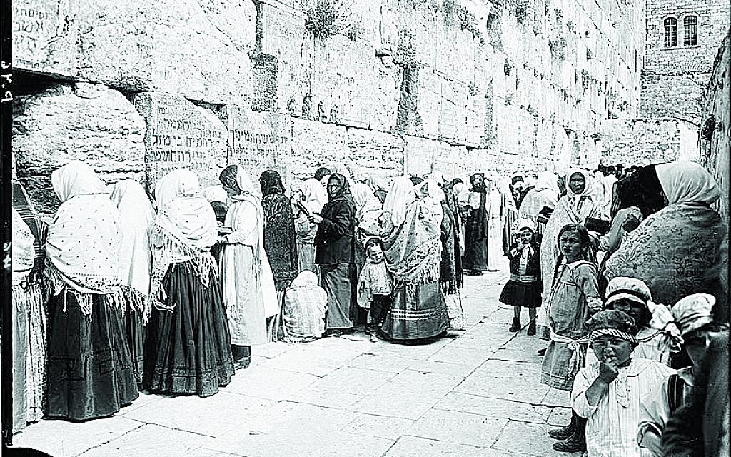 The Western Wall in 1898 with some stones containing writings in Hebrew, believed to be the work of visitors who wanted to commemorate their names upon the wall.