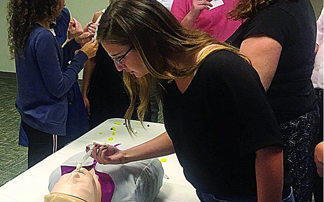 Georgia Hillel staff practice administering Narcan, the drug used to reverse an opioid overdose.