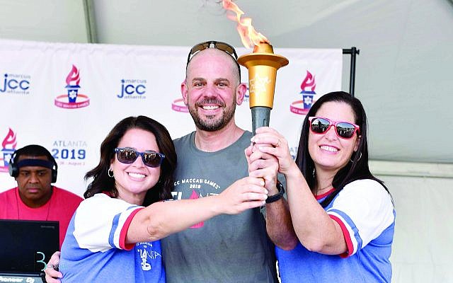 Carrying the torch of the Maccabi Games are Amy Rubin, Jared Powers and Libby Hertz.