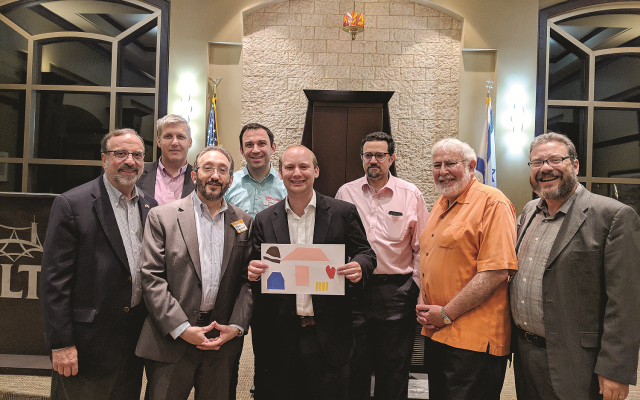 Showing off artwork are Rabbis Neil Sandler (AA), Laurence Rosenthal (AA), Mark Zimmerman (Beth Shalom), Hillel Konigsburg (B'nai Torah), Dan Dorsch (Etz Chaim), Josh Heller (B'nai Torah), Shalom Lewis (Etz Chaim) and Michael Bernstein (Gesher L'Torah).