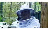 Michelle Harvey and her son, Max, dress in beekeeping suits in order to tend to their hive.