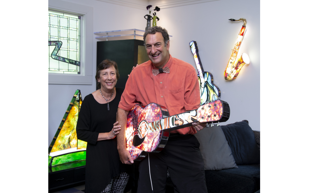 Photos by Duane Stork unless otherwise noted // Diane and Paul Heller transferred their love of music into his art, creating illuminated 3-D glass with instruments … especially guitars. Note the saxophone on the wall where Paul uses real instrument pieces in his sculptures. A Heller sailboat is on the left.