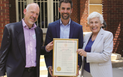 Mayor-Elect Kelly Girtz, Hillel at UGA Director Roey Shoshan, and Mayor Nancy Denson hold a governor's proclamation marking the 20th anniversary.