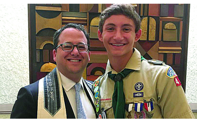 Rabbi Brad Levenberg presented the Etz Chaim  emblem to Ethan Hartz.