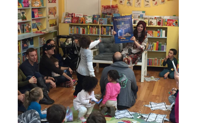 Bracha Slavaticki of Chai Decatur reads Chanukah books to children at Little Shop of Stories.